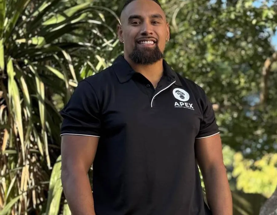 A friendly APEX Property Solutions team member in branded uniform on the Central Coast