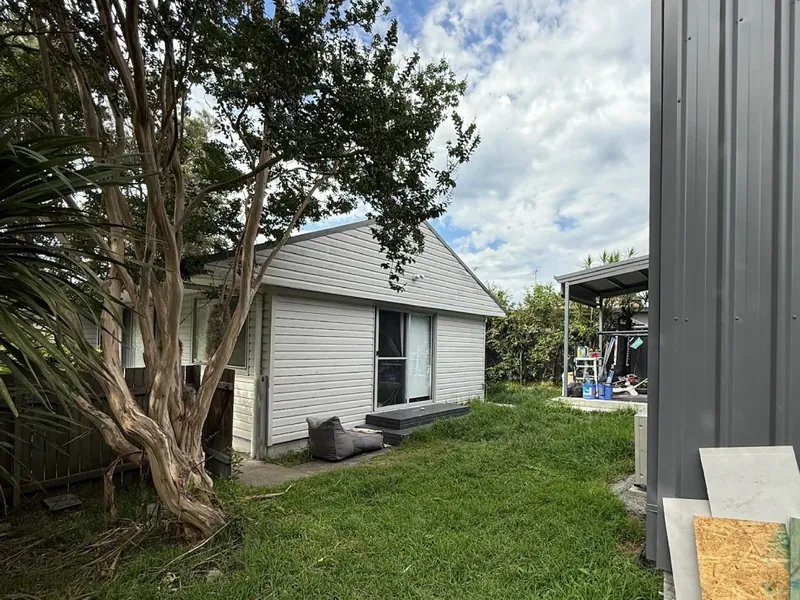 A neat home exterior and garden bed maintained by APEX on the Central Coast